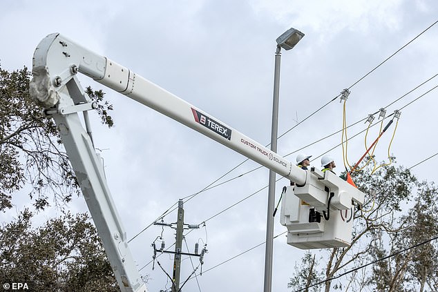 Utility workers repairing power lines after Hurricane Milton in Englewood, FL on October 11