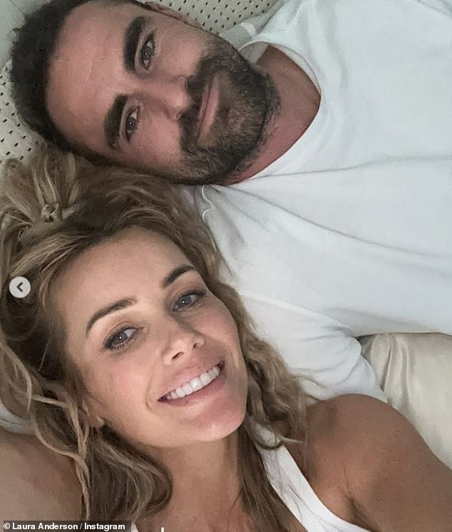 Sharing several snaps of the couple, Laura also posted a cozy smiling selfie of the pair relaxing in bed together.