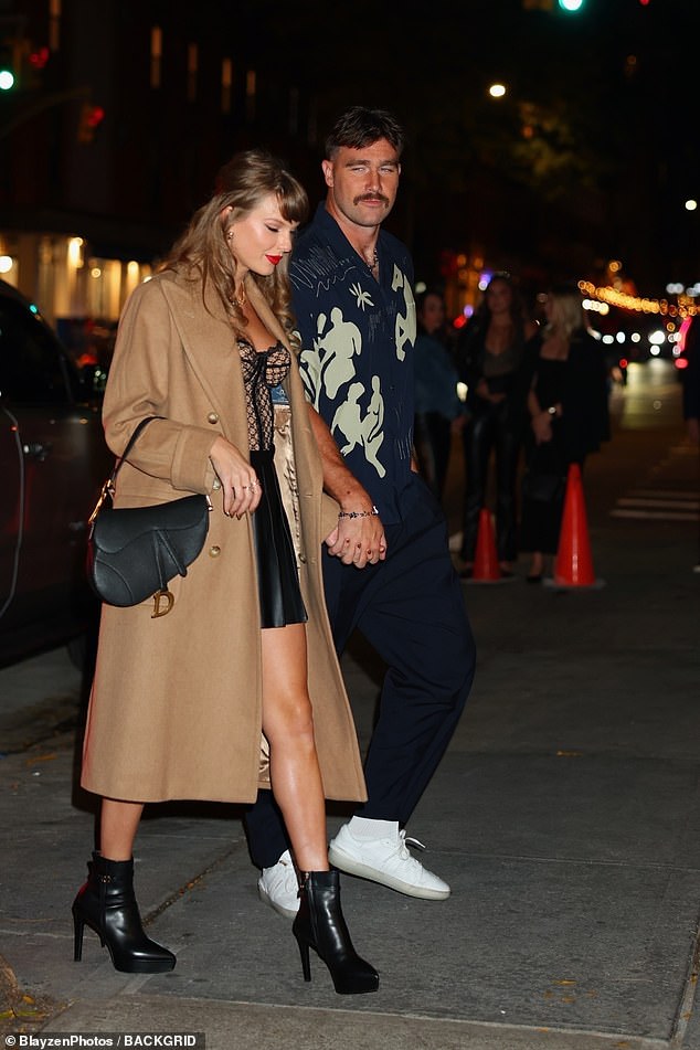 Taylor covered up in a long beige double-breasted coat as she strutted alongside her Super Bowl-winning boyfriend.