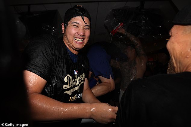 Dodgers' Shohei Ohtani celebrates in the locker room after defeating the Padres