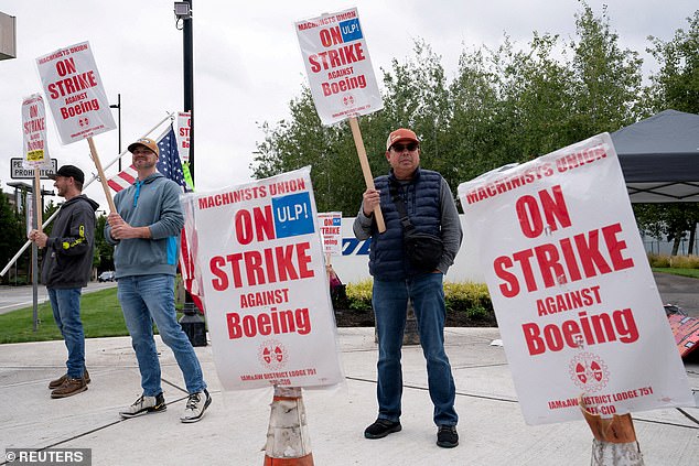 Boeing factory workers and their supporters gather on a picket line during the strike near the entrance to a Boeing production facility in Renton, Washington.