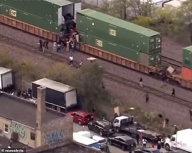 The men then hand the load to other people who carry it across the tracks to waiting trucks.