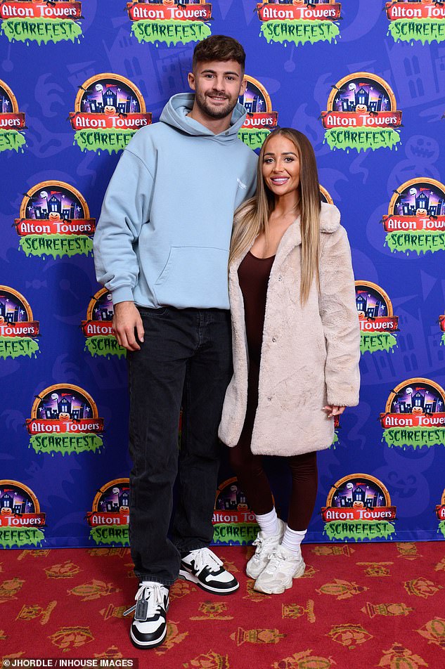 Ciaran Davies and Nicole Samuel also put on a cozy display on the red carpet as they snuggled up for photos.