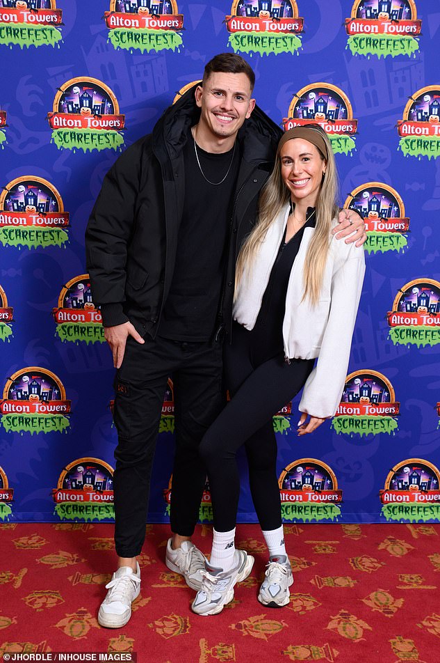 Love Is Blind star Jake Singleton-Hill cut a casual figure in a black quilted coat and fitted trousers as he smiled alongside his girlfriend Catherine Richards.