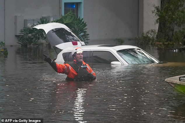 A lifeguard in the water outside a flooded apartment complex after Hurricane Milton on October 10, 2024, in Clearwater, Florida.