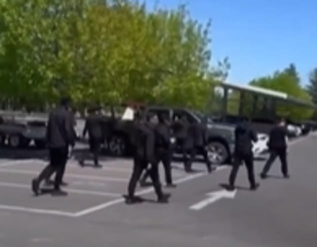 The figures, dressed in black from head to toe, were heard chanting white supremacist slogans before marching toward the city's war memorial.