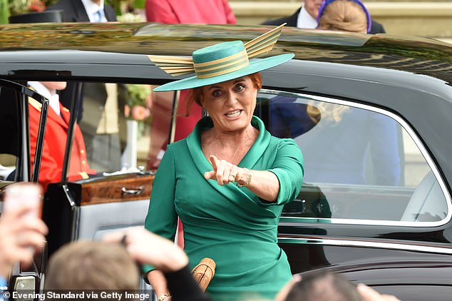 The bride's mother, Sarah Ferguson, sees people she knows when she arrives at the wedding.