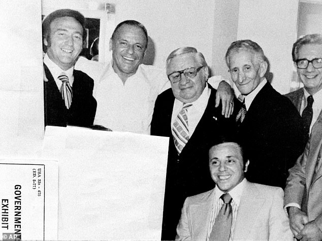 Posing with mob friends in his dressing room in 1976. Left to right: Gregory De Palma, Sinatra, Thomas Marson, Carlo Gambino, Jimmy 'The Weasel' Fratianno and, front, Richard 'Nerves' Fusco. The photo was introduced as evidence during the trial of De Palma and Fusco for fraud.