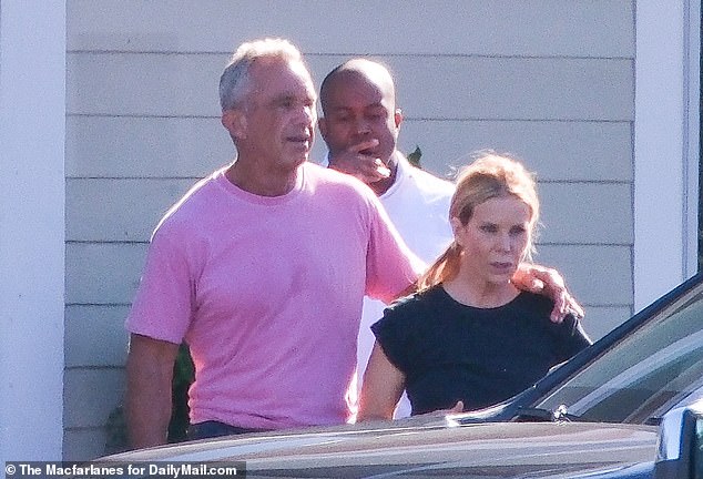 RFK Jr put his arm around his wife and hugged her before the two got into a car and headed to a nearby gym.