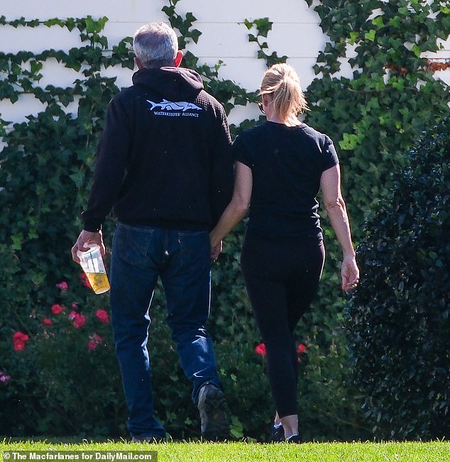 Exclusive photos from DailyMail.com show the couple holding hands at the Kennedy Compound in Hyannis Port, forming a united front before the funeral.