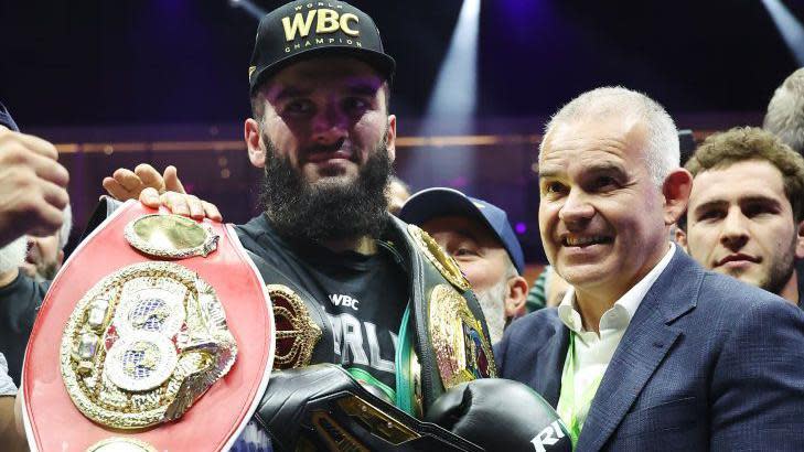 Artur Beterbiev celebrates with his belts