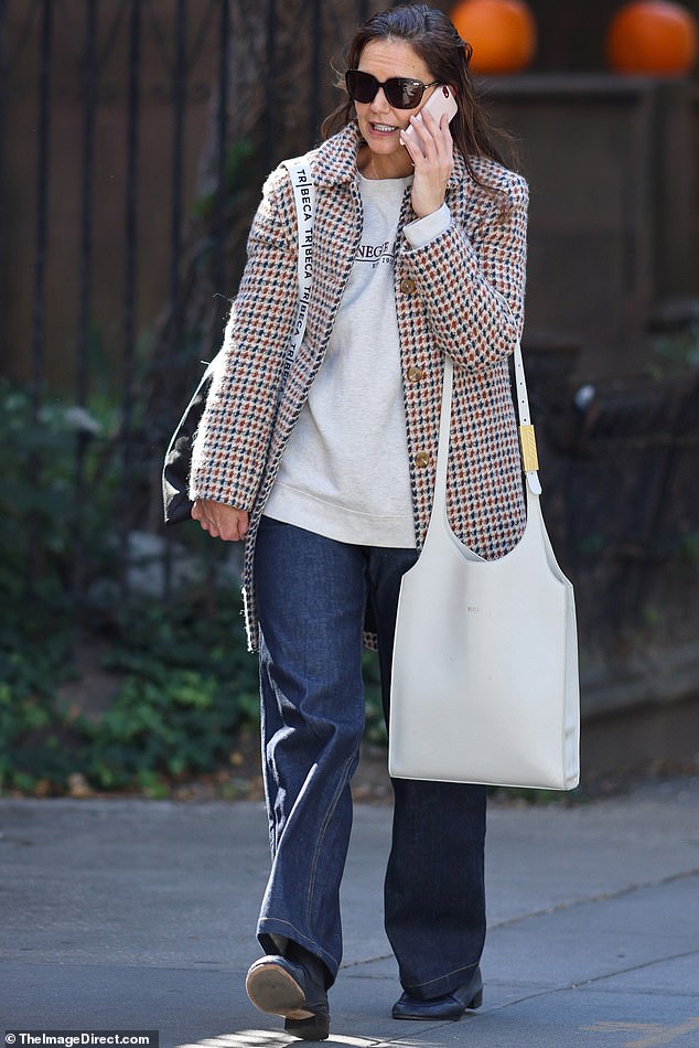 When out on the town over the weekend, Katie, 45, was bundled up in a trendy multi-coloured houndstooth coat.