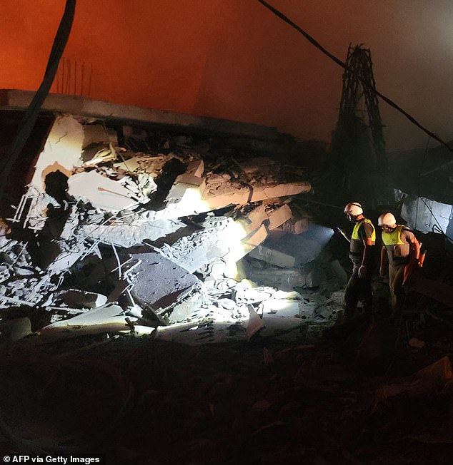 Rescuers begin searching for survivors in the rubble.