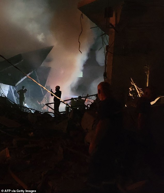 Rescuers search for survivors at the site of an Israeli airstrike that targeted the southern Lebanese city of Nabatiyeh on October 12, 2024.