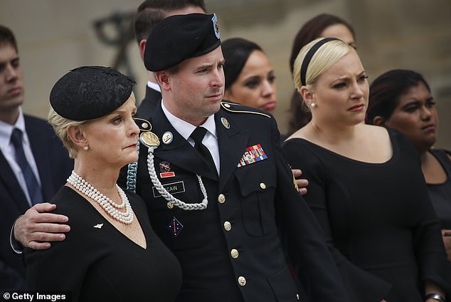 John McCain's son, Jimmy McCain (center), recently changed his party registration from independent to Democrat and announced he will vote for Harris.