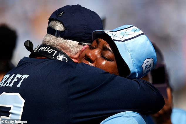 North Carolina Tar Heels head coach Mack Brown (left) hugs Septembre Craft, mother of North Carolina wide receiver Tylee Craft, whose death was revealed Saturday.