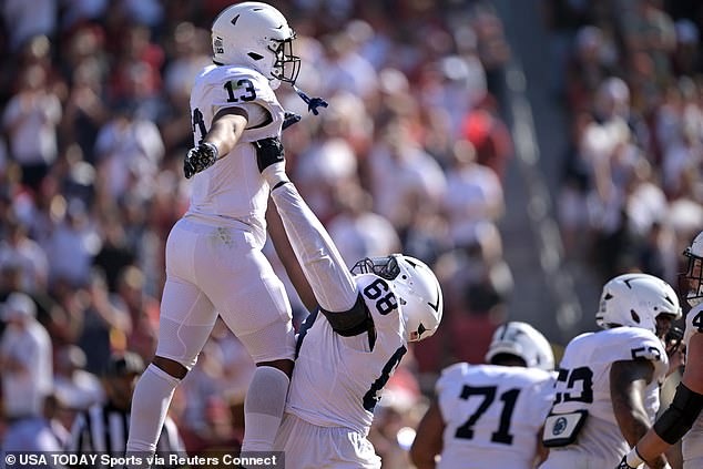 Nittany Lions running back Kaytron Allen (13) is lifted into the air by offensive lineman Anthony Donkoh (68) after scoring a touchdown on Saturday.