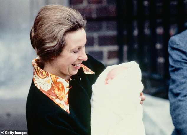 Princess Anne with her hair slicked back and up, holding her daughter Zara as she leaves hospital in 1981.