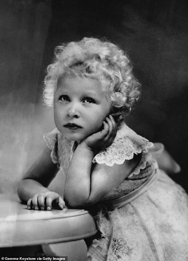 Anne photographed as a toddler with short, tight blonde curls