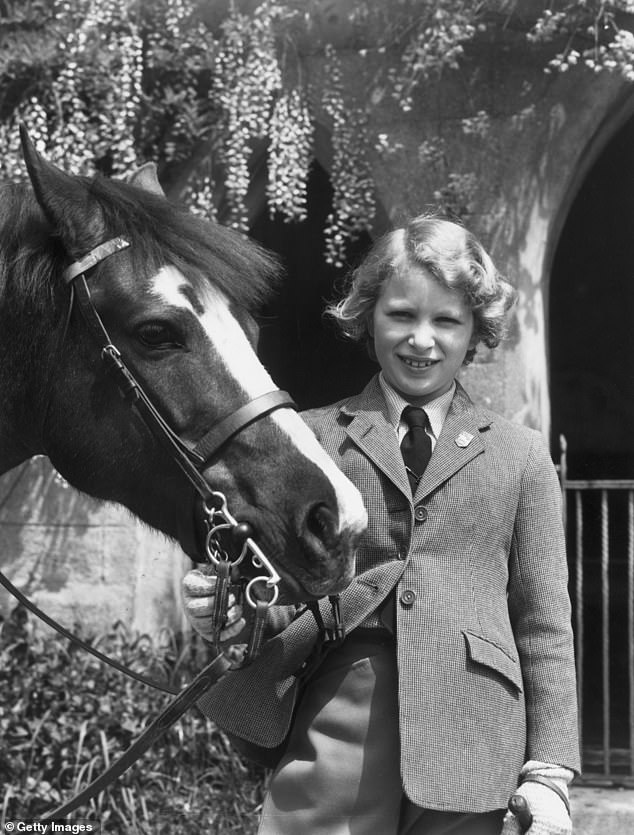 The royal as a child, around 10 years old, in 1960 holding her Welsh pony called Greensleeves in Windsor.