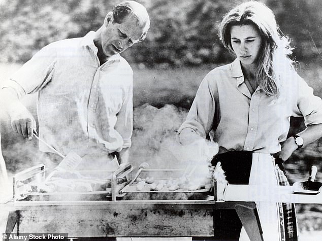 Anne, with long straight hair, having a barbecue with her father, Prince Philip, in 1970.