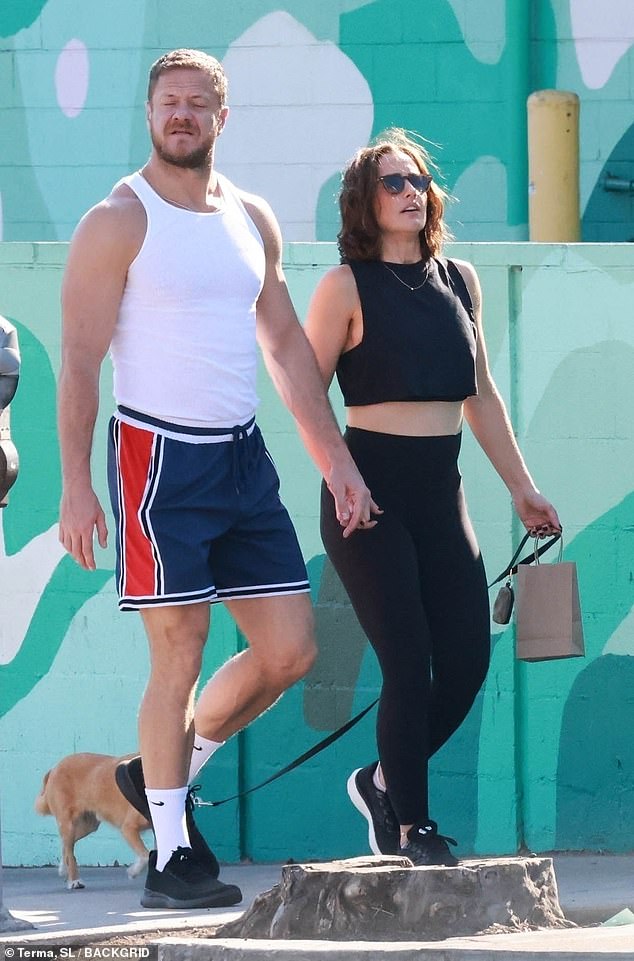 The 37-year-old singer-songwriter showed off his muscular arms in a white tank top and blue Nike shorts with red and white details.