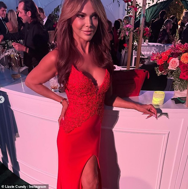 Lizzie looked sensational at the event as she showed off her ample cleavage in a low-cut red dress.