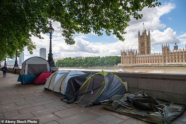 Pictured: People sleeping rough in tents next to the River Thames, opposite the Palace of Westminster, on June 8, 2022.