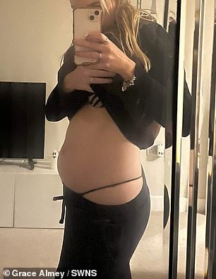 Grace takes a photo of her stomach looking 'pregnant'