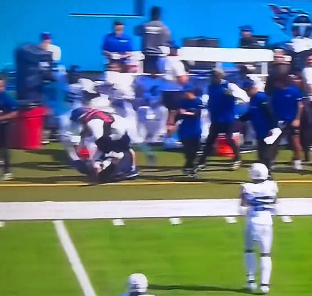 The Titans quarterback accidentally crashed into a sideline, crushing him to the turf.