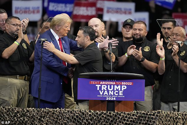 Paul Perez, president of the National Border Patrol Council, hugs Republican presidential candidate, former President Donald Trump.