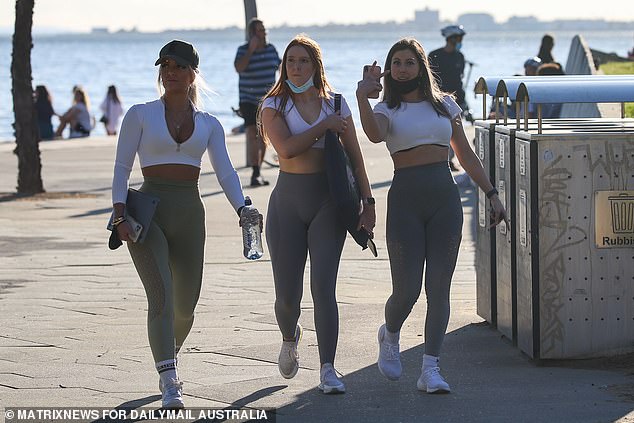 Lawson said Generation Z is shunning apprenticeships due to the low starting salary, but somehow finds the money for expensive lifestyle choices (pictured, young Australians walking on St Kilda Beach in Melbourne).