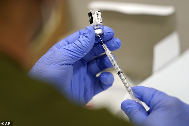 After receiving the Pfizer Covid booster, Lowe developed numbness in his face and pain around his body, which has not subsided in the three years since. Pictured: A syringe is filled with the Pfizer Covid vaccine in October 2021