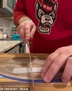 The trick uses a hot knife heated over a gas stove to cut and seal one Ziploc bag into two medium-sized functional Ziploc bags.