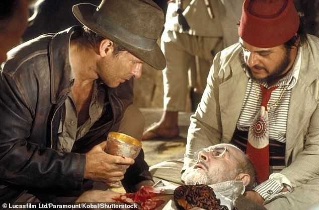 Pictured here is Indiana Jones (Harrison Ford) holding the Holy Grail in the 1989 film 'Indiana Jones and the Last Crusade', with Henry Jones Sr. (Sean Connery) and Sallah (John Rhys-Davies)