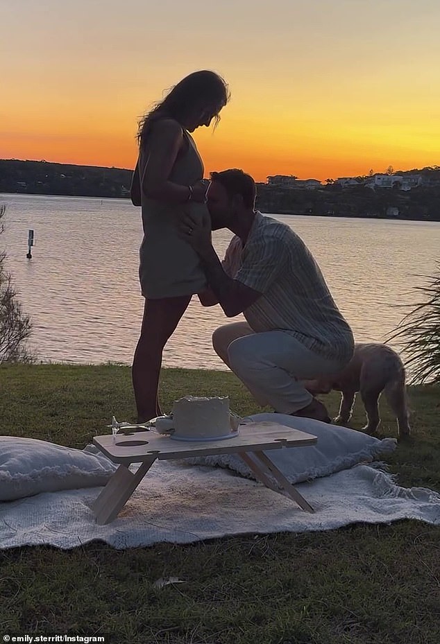 In a sweet video, the newlyweds kissed before using their champagne glasses to remove a piece of the cake and reveal a blue color inside, indicating that they are having a baby.