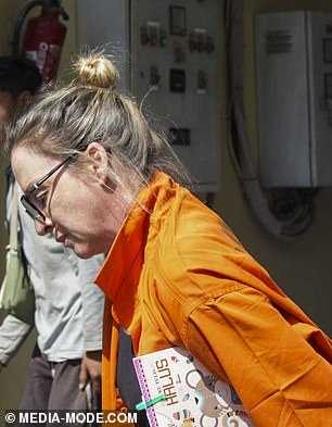 With her wrists handcuffed behind her back, Lynley Le Grand is detained at Bali police headquarters.