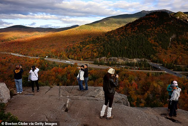 People took photos of the fall foliage while looking down from the top of the Artist Bluff Trail.