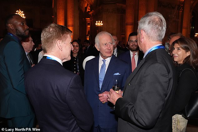 He donned a navy blue suit, which he paired with a blue and white patterned tie, adorned with a matching handkerchief.