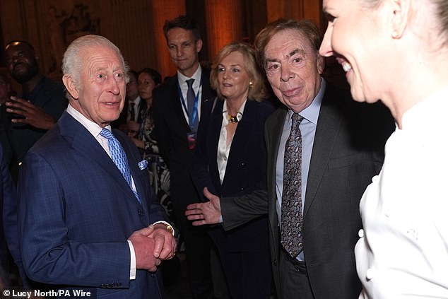 The King smiled as he chatted with international business leaders during tonight's meeting. Pictured chatting with Andrew Lloyd Webber