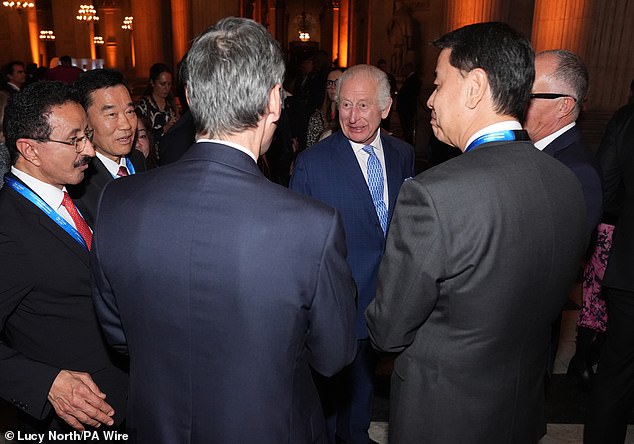 King Charles III speaks to guests during a reception for international business leaders at St Paul's Cathedral