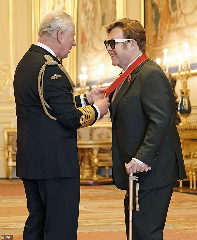 Sir Elton John pictured as Charles appoints him to the Order of the Companions of Honor in 2021