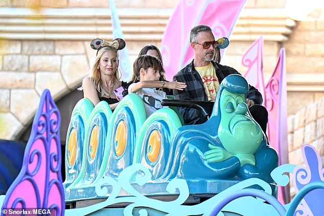 For her outing, Gellar cut a casual figure in a black tank top with ruffled straps, light wash jeans, several gold layered necklaces, and her own pair of Mickey Mouse ears.