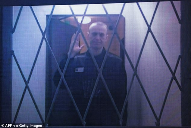 Alexei Navalny seen on a screen via video link from the IK-3 penal colony above the Arctic Circle during a hearing of his complaint about restrictions placed on what books and reading material he can access in prison, at the Court Moscow Supreme Court in January. 11, 2024