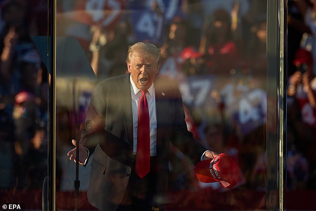 At his outdoor rallies, Trump has spoken from behind a bulletproof glass perimeter since the assassination attempt against him in Butler, Pennsylvania, on July 13. Pictured: Trump at his rally in Coachella, California, on October 12, 2024.