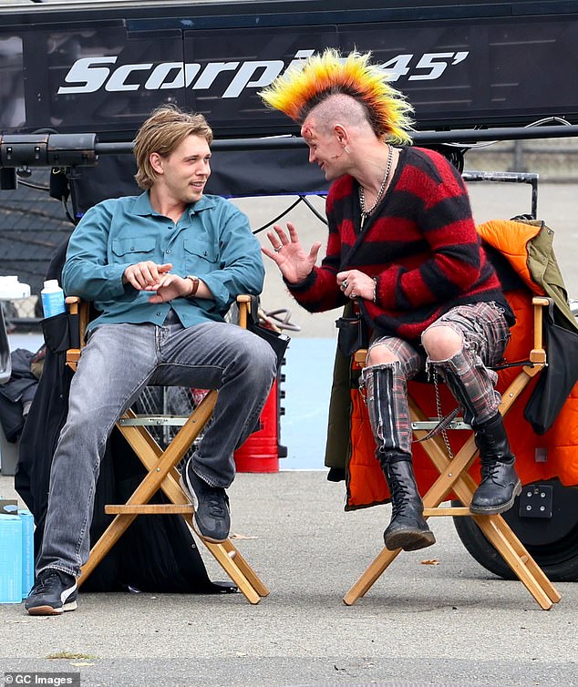 Between takes, Smith wore a red and black flannel sweater while chatting with co-star Butler in their chairs on set.