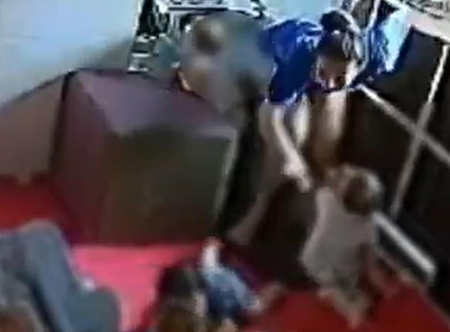 A daycare assistant in Brazil was seen on video hitting the buttocks of a one-year-old girl moments before her colleague bit her left arm.