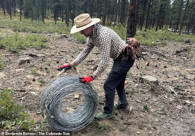 The group maintains that historic treaties and deeds give it ownership of approximately 1,400 acres within the national forest. Several neighbors have gathered to raise the fence.