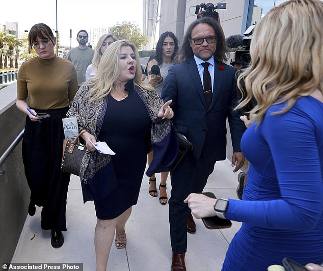 Former Las Vegas City Councilwoman Michele Fiore (center) declines to answer questions after reading a statement to the media outside the Lloyd George U.S. Courthouse in Las Vegas.