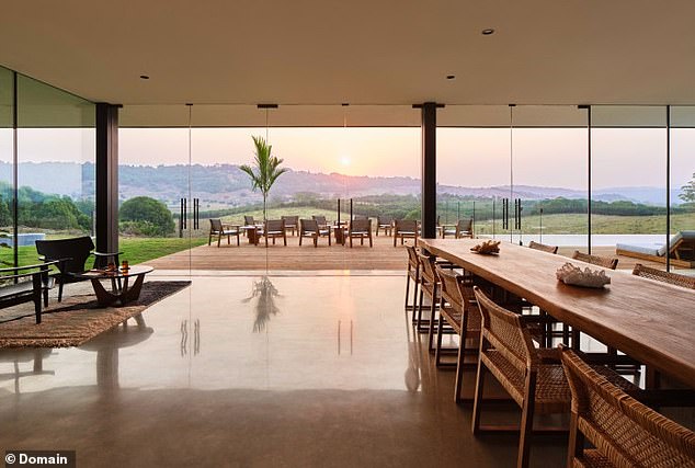 Highlights include floor-to-ceiling windows offering stunning views of the surrounding hills. (Pictured)